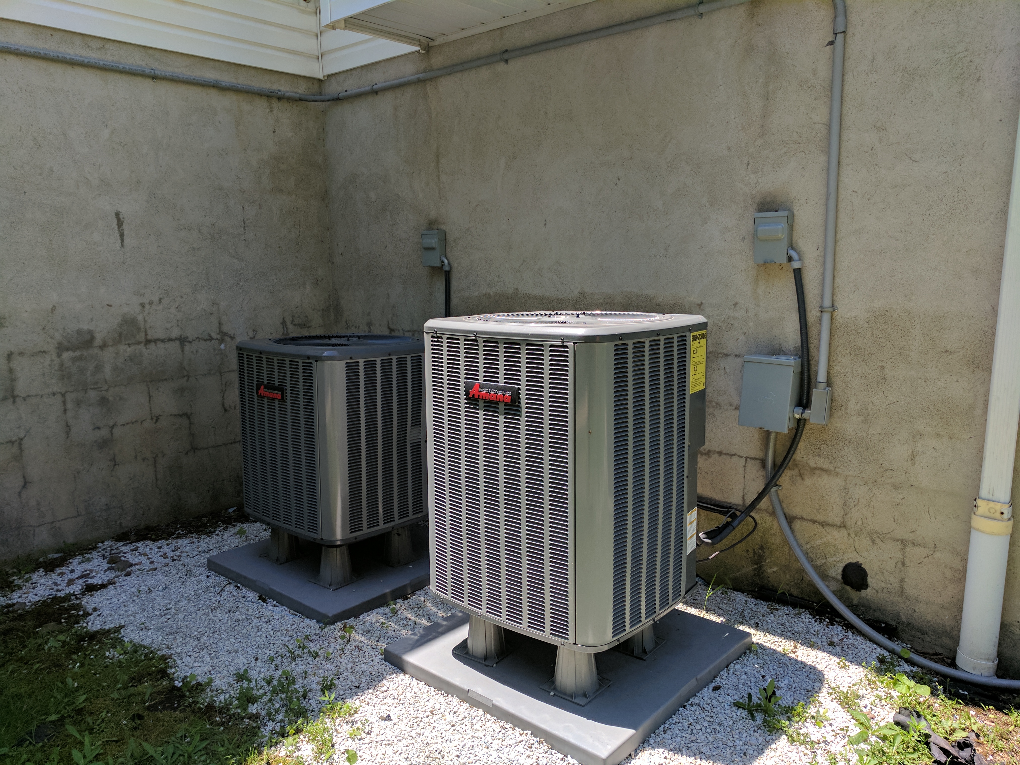 Two outdoor central AC condensers