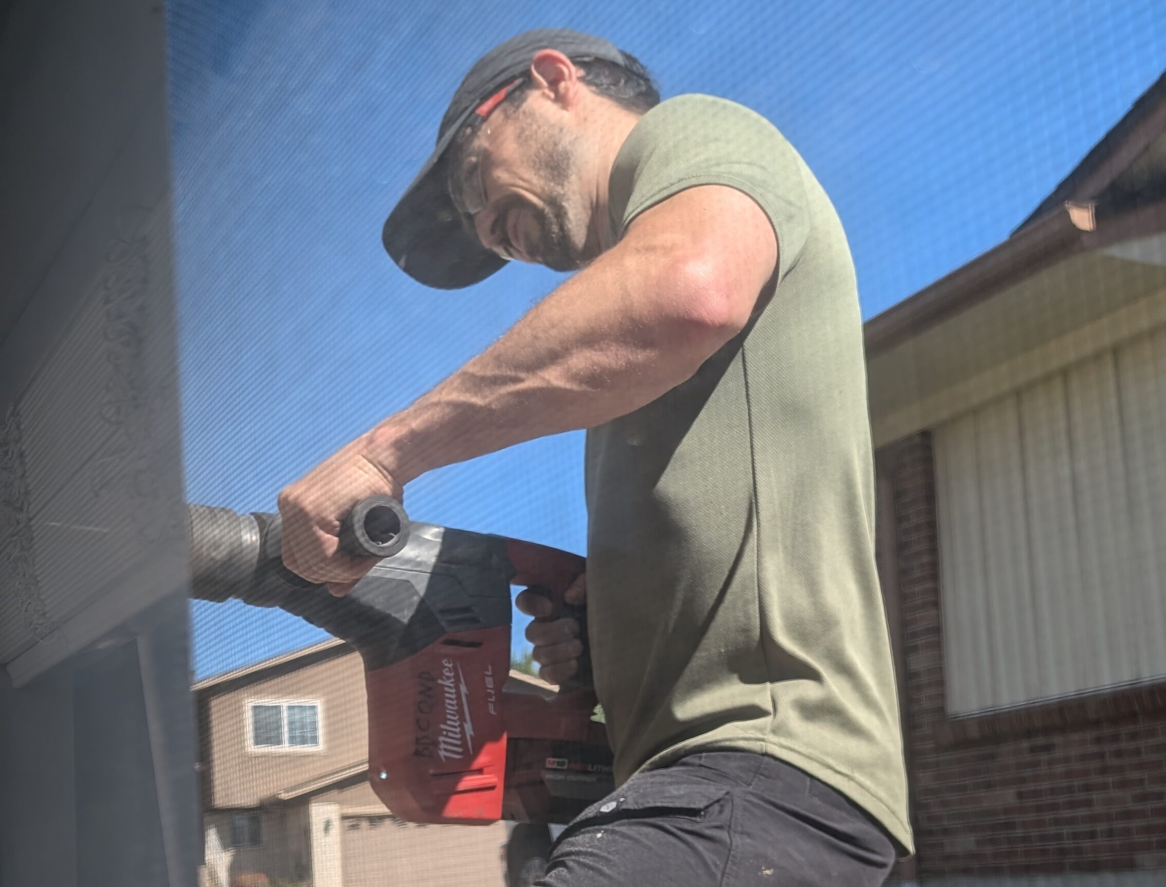 A Bronco Breeze Tech making a hole for a ductless ac instsll