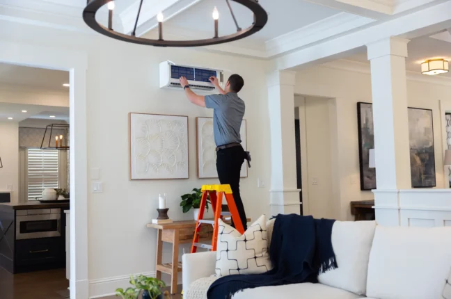 A tech installing a Ductless AC in Denver, Colorado from Bronco Breeze heating and cooling