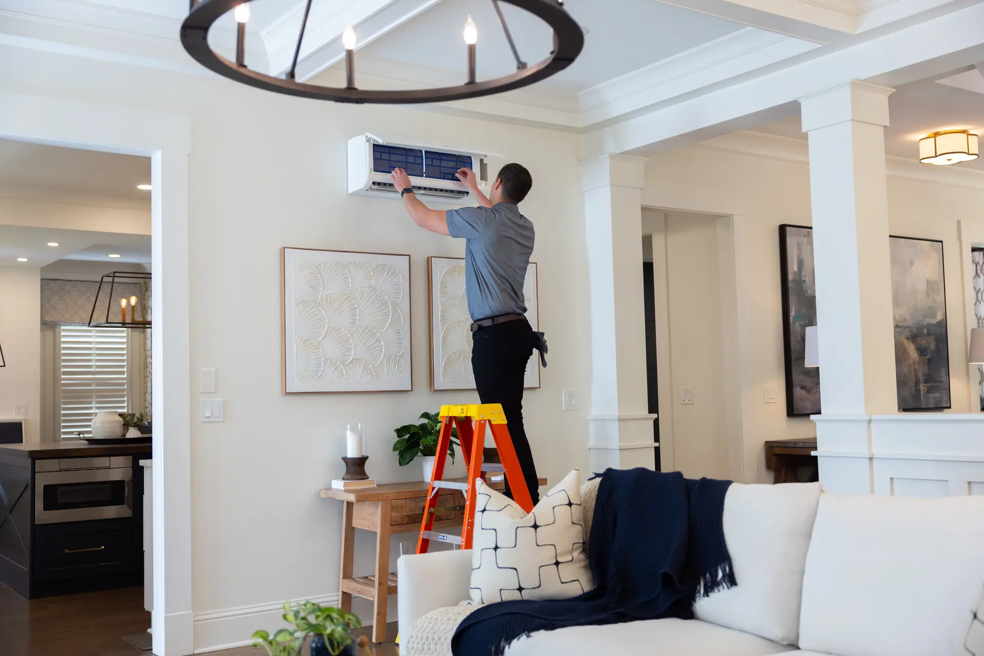 A tech installing a Ductless AC in Denver, Colorado from Bronco Breeze heating and cooling